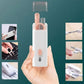 Portable nail care set with scissors and clippers held in a hand against a teal background.