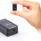 Small GPS tracker held by a hand on a white background