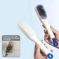 Hairbrush with bristle head and scrubber surface, held by a hand against a light blue background.