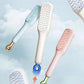 Three hairbrushes in different colors on a light blue background